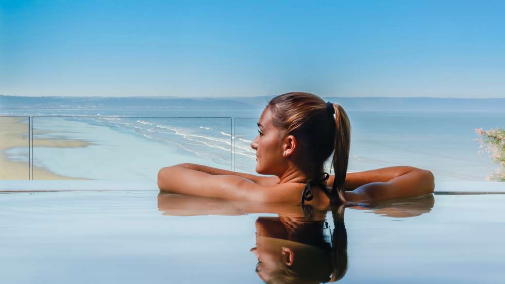 Saunton Sands Hotel Source Spa Guest in Vitality Pool Looking Out on Saunton Beach