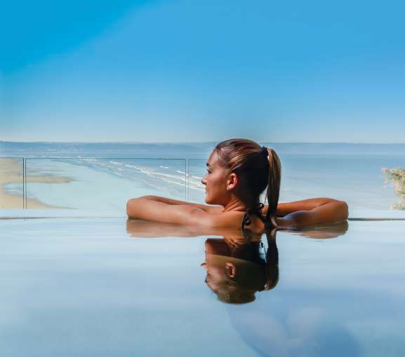Saunton Sands Hotel Source Spa Guest in Vitality Pool Looking Out on Saunton Beach