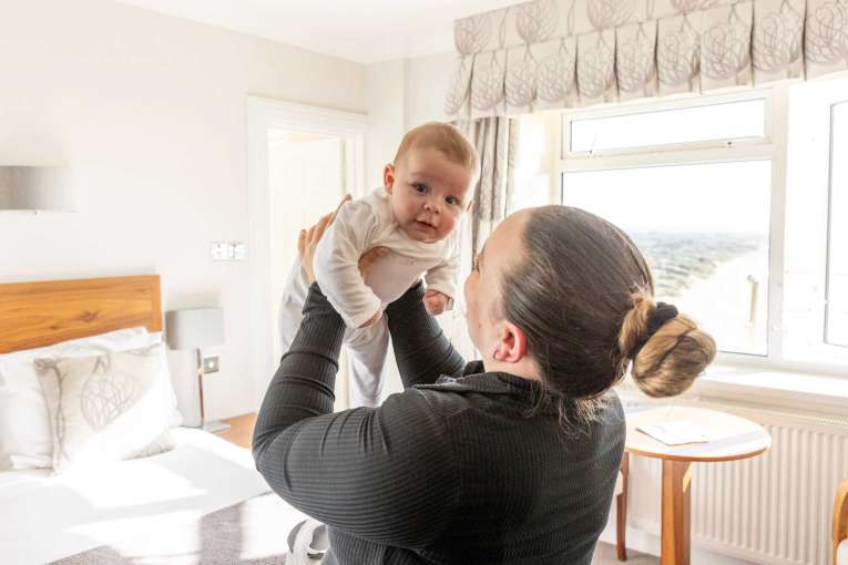 Mother and baby in bedroom