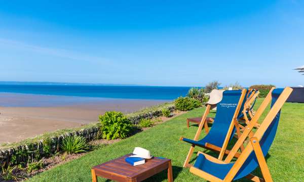 Two Saunton Sands Hotel deck chairs facing out to sea