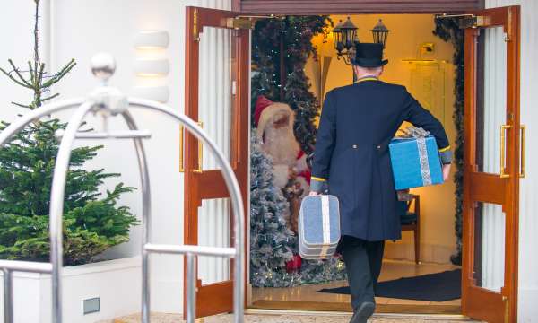 Doorman walking into festive hotel